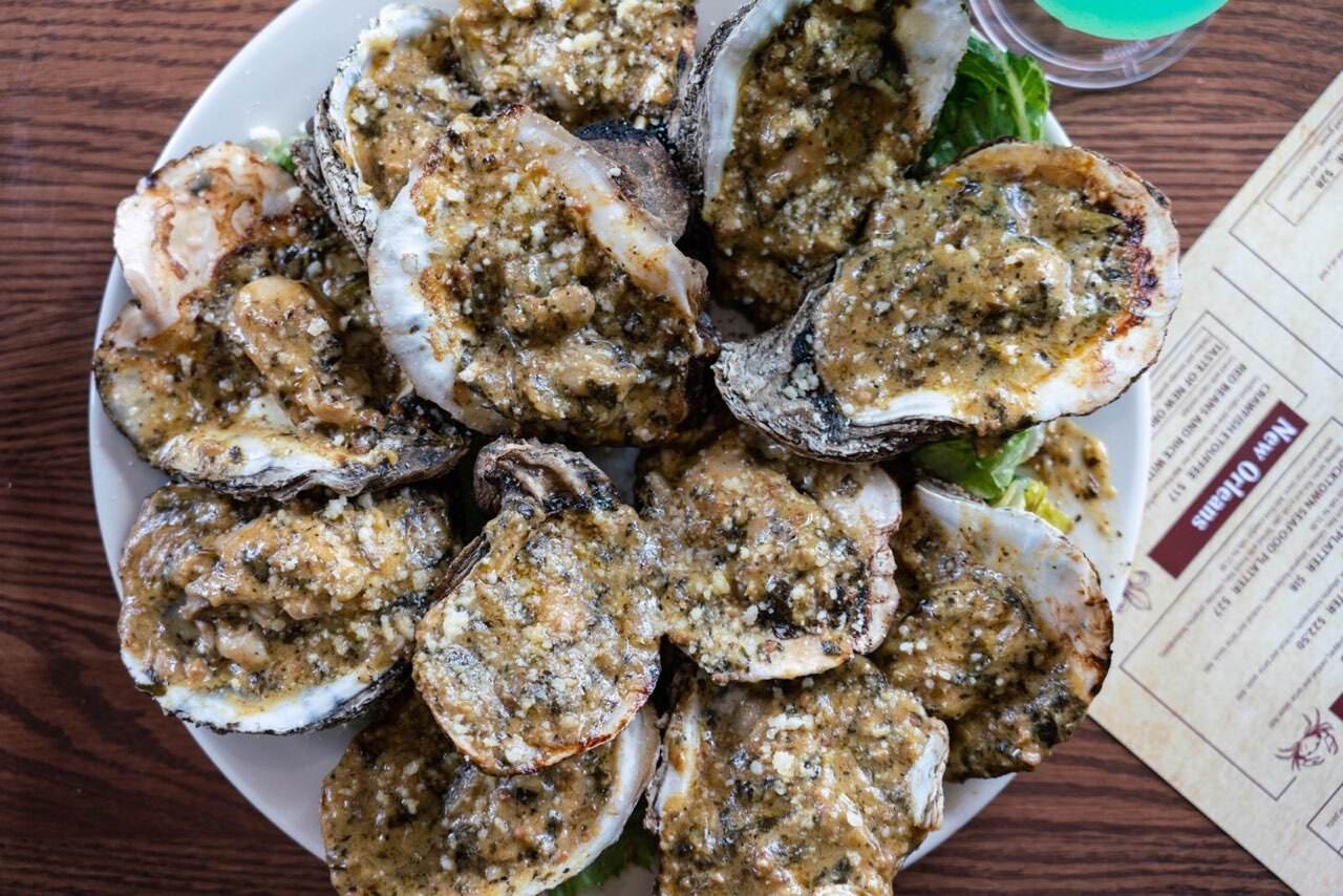 Oysters Rockefeller on the half shell, baked with spinach, smoked bacon and Parmesan