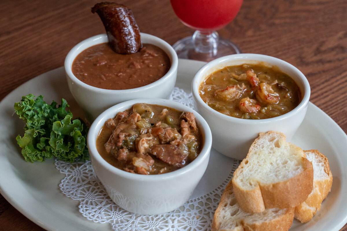 Taste of New Orleans sampler: bowls of gumbo, crawfish étouffée and red beans with smoked sausage, with French bread